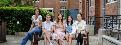 Group photo of 2023/24 Officer Trustees, sitting on a bench in Beit Quad